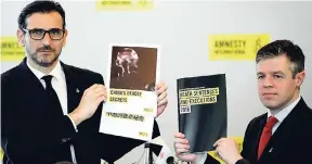  ?? AP ?? In this Monday, April 10, 2017 photo, Amnesty Internatio­nal East Asia Director Nicholas Bequelin (left) and Deputy Director of Global Issues James Lynch hold the copies of reports on the death penalty during a press conference in Hong Kong.