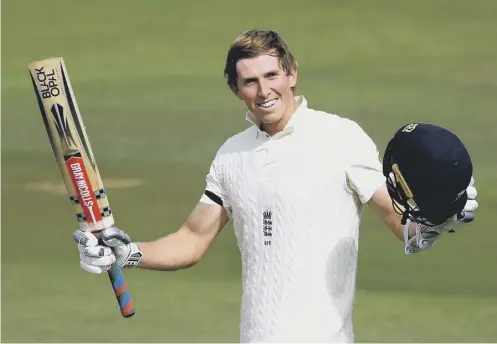  ??  ?? 0 England batsman Zak Crawley raises his bat after passing three figures on his way to a score of 171 not out at stumps at the Ageas Bowl.