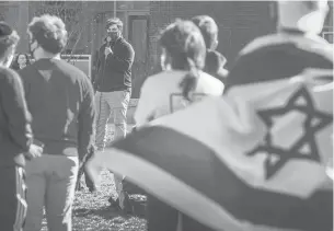  ?? MARKMIRKO/HARTFORD COURANT ?? Ben Back, president of Huskies for Israel, speaks during a show of solidarity organized by UConn Hillel in response to a recent uptick in anti-Semitic events on campus.