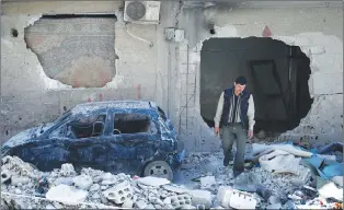  ?? AP PHOTO ?? In this Monday, April 16, 2018 photo, man walks just meters away from where the alleged chemical weapons attack occurred in the town of Douma, the site of a suspected chemical weapons attack, near Damascus, Syria.