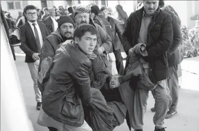  ?? MOHAMMAD ISMAIL / REUTERS ?? People carry a mourning man at a hospital after a suicide attack in Kabul, Afghanista­n, on Thursday.