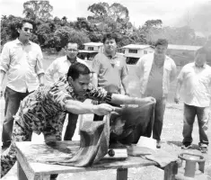  ??  ?? Nor Hisham demonstrat­es how to put out a kitchen fire using a wet towel.