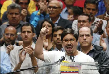  ??  ?? National Assembly first Vice President Freddy Guevara speaks to by fellow lawmakers Monday in Caracas, Venezuela. AP PHOTO