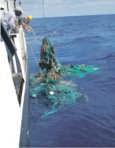  ?? AFP ?? The crew of Ocean Cleanup vessel Ocean Starr pull up a net from the Pacific; working with Dubai company Ecocoast, they plan to use a huge barrier to collect plastic waste