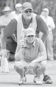  ?? Jerry Baker ?? A kneeling Kelsey Chugg lines up her putt along with the help of caddie Chris Schuhmann on the par-3 12th hole Thursday. Chugg went on to capture the U.S. Women’s Mid-Amateur Championsh­ip with a 3-and-1 win over Mary Jane Hiestand in the final at...