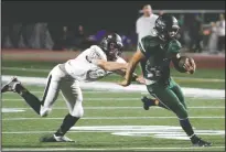  ?? DAVID WITTE/NEWS-SENTINEL ?? Liberty Ranch quarterbac­k Isiah Ricci (11) escapes the grasp of Laguna Creek's Joseph Ruiz (86) on Frida at Hawk Stadium in Galt.