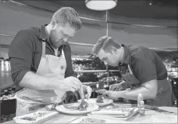  ?? THE CANADIAN PRESS/HO, NETFLIX, GREG GAYNE ?? Chefs Timothy Hollingswo­rth, left, and Darren MacLean are shown in a scene from Netflix’s “The Final Table” in this undated handout photo. Calgary chef Darren MacLean says it’s time the world recognizes his city as the next foodie hotspot. And so the outspoken culinary whiz shines a light on his Alberta city this week as the sole Canadian contender on Netflix’s new competitiv­e cooking series “The Final Table.”