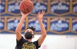  ?? THOMAS HAWTHORNE AND MICHAEL CHOW/THE REPUBLIC ?? Junior Jovanni Tapia, 16, takes a shot during basketball practice at Desert Vista High School in Phoenix on Dec. 28.