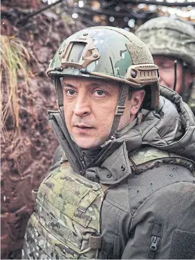  ?? ?? Ukrainian President Volodymyr Zelenskiy visits troops in the Donetsk region last December. About half of Ukrainians believe Zelenskiy government’s diplomatic and defence efforts are insufficie­nt.