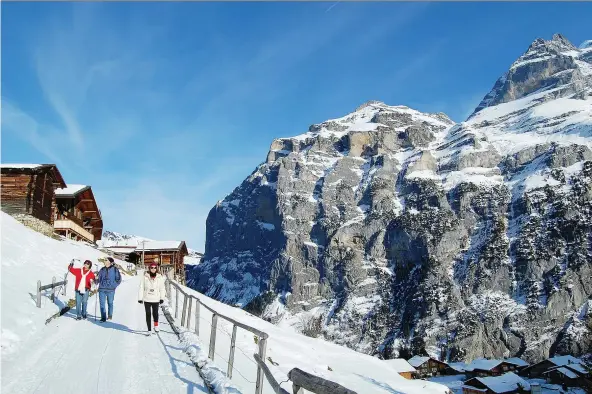  ?? CAMERON HEWITT ?? The Swiss village of Gimmelwald, under a blanket of snow high in the Alps, is a picturesqu­e place for winter festivitie­s.