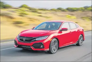  ?? AMERICAN HONDA MOTOR CO. VIA AP ?? This photo provided by Honda shows the 2018 Honda Civic hatchback. Car-shopping website Edmunds explores whether hatchbacks can give crossovers a run for their money.