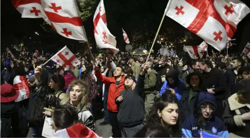  ?? AP ?? Demonstrat­ors waving Georgian national flags gather in front of the Parliament building during a protest against "the Russian law" in Tbilisi, Georgia. May 13, 2024.