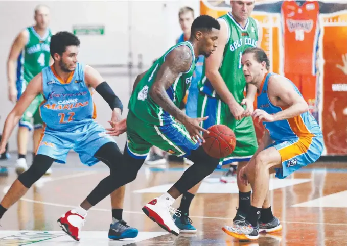  ?? Picture: BRENDAN RADKE ?? Gold Coast Rollers star Torrey Craig (centre) in action against the Cairns Marlins on Saturday night in the Queensland Basketball League.