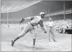  ?? MATTY ZIMMERMAN — ASSOCIATED PRESS FILE ?? Kansas City Monarchs pitcher Satchel Paige warms up at New York’s Yankee Stadium before a 1942 Negro League game against the New York Cuban Stars.