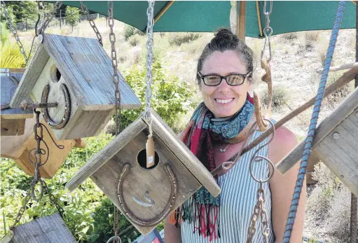  ?? PHOTO: JARED MORGAN ?? For the birds . . . Ettrick artist Vauna Turner stands among some of the bird houses she has crafted from fruit pallets which she had for sale at Art in The Garden at the weekend.