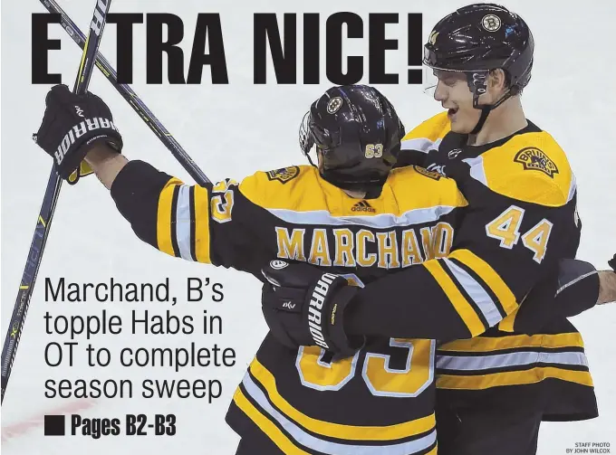  ?? STAFF PHOTO BY JOHN WILCOX ?? WINNING FORM: Brad Marchand is embraced by Bruins teammate Nick Holden, right, after scoring the overtime goal against the Canadiens last night at TD Garden.