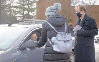  ?? HEATHER MONGILIO/CAPITAL GAZETTE ?? Shaneirah Colbert signs paperwork before receiving her $500 gift card.