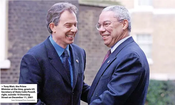  ?? Sean Dempsey/Press Associatio­n ?? > Tony Blair, the Prime
Minister at the time, greets US Secretary of State Colin Powell, right, outside 10 Downing Street on December 11, 2001