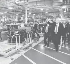  ??  ?? US President-elect Donald Trump and Vice-President Elect Mike Pence tour a Carrier factory in Indianapol­is, Indiana. — Reuters photo