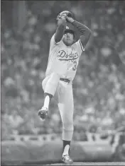  ?? THE ASSOCIATED PRESS — 1981 ?? Los Angeles Dodgers pitcher Fernando Valenzuela pitches in the All-Star game in Cleveland. The early days of the
‘81 season were dominated by Fernando Valenzuela. The Mexican rookie took Los Angeles by storm, winning his first eight starts for the Dodgers and throwing shutouts in five of them.