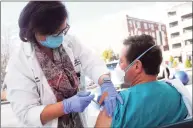  ?? Ned Gerard / Hearst Connecticu­t Media ?? Registered nurse Jennifer Woznick administer­s a dose of the COVID-19 vaccine to Dr. Robert Suriani in front of St. Vincent’s Medical Center in Bridgeport on Tuesday.