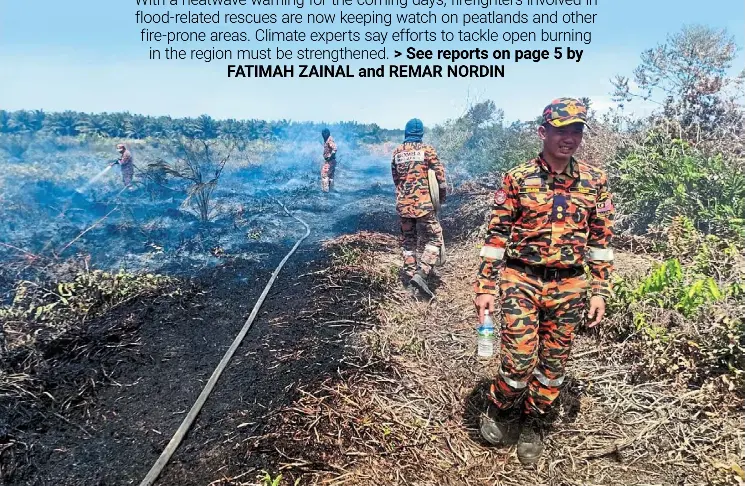  ?? ?? Firemen having a tough time putting out a fire on peatland in Sabah. — Photo courtesy of Kuala Penyu Fire and Rescue Department Undergroun­d blaze: