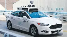  ?? WICKERHAM/THE ASSOCIATED PRESS JARED ?? A self-driving Ford Fusion hybrid car is test driven in Pittsburgh.