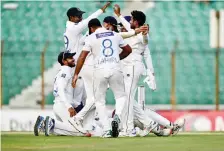  ?? — AFP ?? Sri Lankan players celebrate after the dismissal of Bangladesh’s Shakib Al Hasan during the fourth day of the second Test in Chittagong.