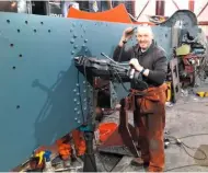  ?? DAVE OWEN ?? Chris Collins drilling holes for the horn bolts in No. 4709’s frames at Llangollen on January 31.