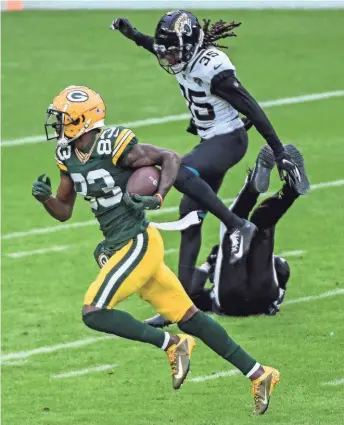  ?? BENNY SIEU / USAT ?? An official falls to the ground as Packers wide receiver Marquez Valdes-Scantling scores a touchdown against the Jaguars in the second quarter.