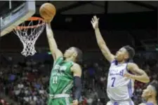  ?? RICK BOWMER — THE ASSOCIATED PRESS ?? Boston Celtics forward Jayson Tatum (11) lays the ball in as Philadelph­ia 76ers guard Markelle Fultz (7) defends during the second half of an NBA summer league basketball game Monday in Salt Lake City.