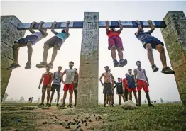  ?? — PTI ?? Youth perform physical exercises in preparatio­ns for recruitmen­ts in security forces in Ranbir Singh Pura sector of Jammu on Friday.