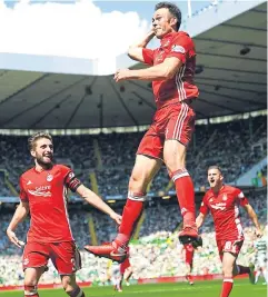  ?? Picture: SNS Group. ?? Aberdeen’s Andrew Considine celebrates with team-mates after he fires the away side in front – and secures the north-east club second place.