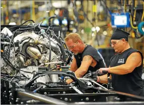  ?? ASSOCIATED PRESS FILE ?? Ford Motor Company’s F-650/F-750medium-duty trucks roll off the line for the first time at the Ohio Assembly Plant in Avon Lake in August 2015.