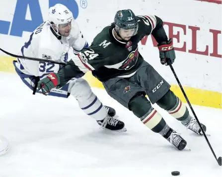  ?? HANNAH FOSLIEN/THE ASSOCIATED PRESS ?? Minnesota Wild defenseman Matt Dumba has the puck against Toronto Maple Leafs left wing Josh Leivo during the second period on Thursday, in St. Paul, Minn.