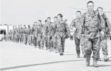  ??  ?? Japanese peacekeepe­rs arrive at the Juba airport to participat­e in the United Nations Mission in South Sudan (UNMISS) in South Sudan’s capital Juba. — Reuters photo