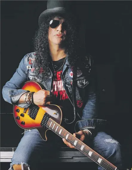  ?? Francine Orr Los Angeles Times ?? “I REALLY, really dig playing in the Conspirato­rs,” says guitarist Slash. “It’s just a little, simple rock ’n’ roll band, and I love that.”