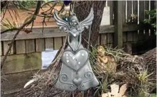  ??  ?? Visitors are welcome to place an angel on Alma Williams’ angel tree in honour of a loved one lost to cancer. Over the years, dozens of angels have gathered in Alma’s garden.
