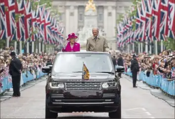  ?? Arthur Edwards/WPA Pool/Getty Images ?? Queen Elizabeth II and Prince Philip wave to guests attending “The Patron’s Lunch” celebratio­ns for the queen’s 90th birthday on The Mall on June 12, 2016, in London.