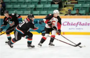  ?? CITIZEN PHOTO BY JAMES DOYLE ?? Austin Crossley of the Prince George Cougars keeps the puck away from Kelowna Rockets forward Ted Brennan on Wednesday night at CN Centre. The Cats are back on home ice tonight and Saturday against the Victoria Royals.