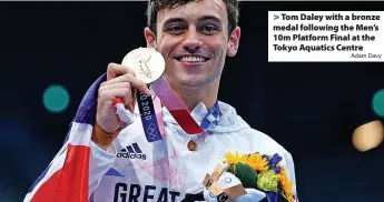  ?? Adam Davy ?? > Tom Daley with a bronze medal following the Men’s 10m Platform Final at the Tokyo Aquatics Centre