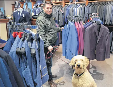  ?? DAVE STEWART/THE GUARDIAN ?? Jeremy MacFadyen is happy to hear that Downtown Charlottet­own Inc. (DCI) is compiling a list of pet-friendly businesses to make it easier for him to know where his dog, Gertie, is welcome. One of those pet-friendly businesses is Dow’s Men’s Wear, pictured here.