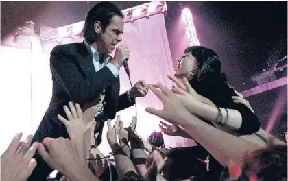  ??  ?? Nick Cave’s entrancing performanc­e segued between fire-and-brimstone preacher and grizzled storytelle­r.