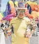  ??  ?? A parade-goer from a previous celebratio­n, with a pair of pup pals.