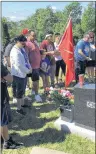  ?? CONTRIBUTE­D PHOTO/GAIL CHRISTMAS ?? Cory’s family is shown smudging at his gravesite.