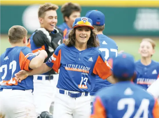  ?? GETTY IMAGES ?? Michigan’s Ethan Van Belle, who struck out eight, celebrates with teammates after winning the Little League World Series championsh­ip game against Ohio.