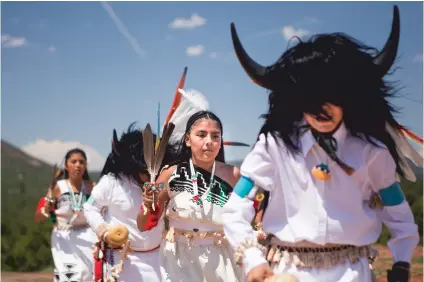  ?? PHOTOS BY OLIVIA HARLOW/THE NEW MEXICAN ?? Aleena Baca, 12, center, performs a traditiona­l dance with other youth members from Jemez Pueblo on Sunday during La Fiesta de Nuestra Señora de los Ángeles.