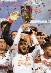  ?? ELSA / GETTY IMAGES ?? Hector Villalba celebrates with the Eastern Conference trophy after the United clinched a spot in the MLS Cup last Thursday.