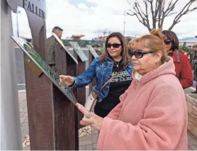  ?? ?? Family members of fallen U.S. Border Patrol agents look at the deceased agents’ names on the El Paso Sector Fallen Agent Memorial after it was unveiled Wednesday in El Paso.