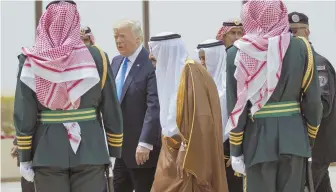  ?? AP PHOTO ?? GETTING DOWN TO BUSINESS: President Trump walks with Saudi King Salman during a welcome ceremony at the Royal Terminal of King Khalid Internatio­nal Airport.